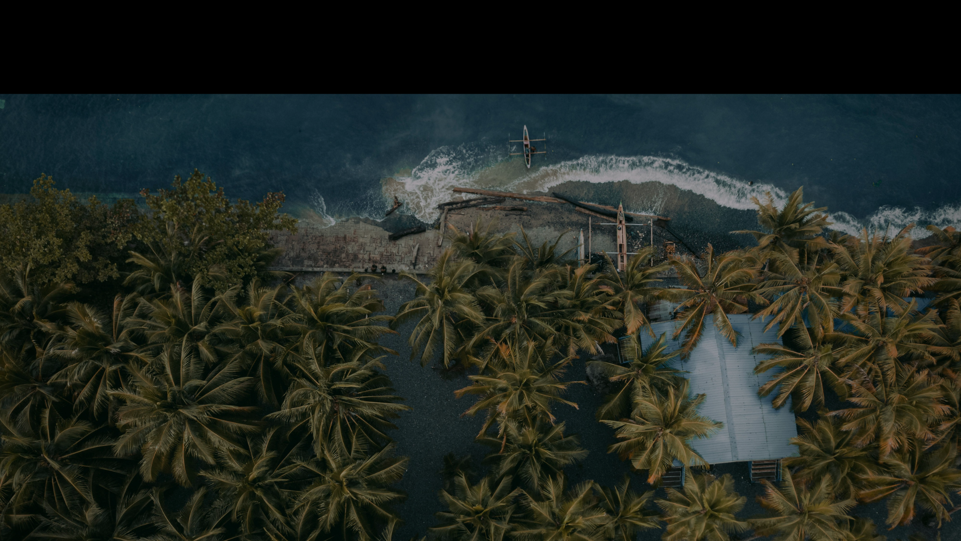 Coastal village surrounded by tropical forest in Indonesia
